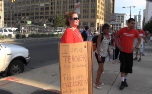 A Philadelphia teacher protests budget cuts during a rally outside School District Headquarters (Photo by Solomon Jones)